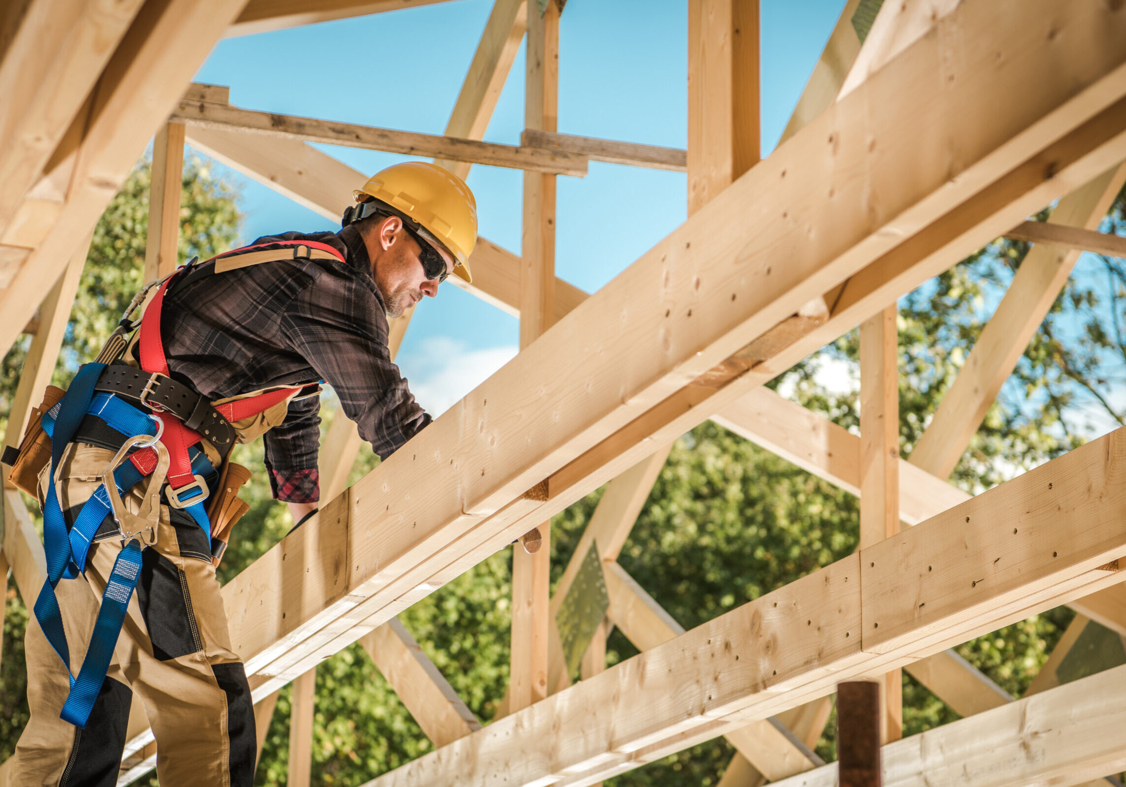 Wood House Frame Construction. Industrial Theme. Caucasian Contractor Worker.